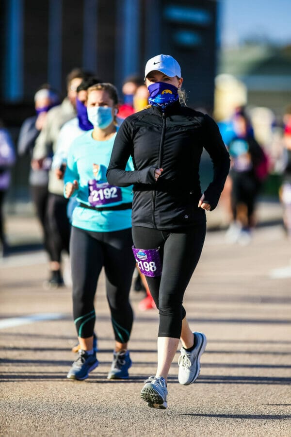 Ocean State Rhode Races Gaiter worn by a female runner in black jacket