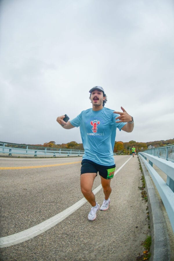 2023 Ocean State Rhode Races Official 5K T-shirt worn by a male runner